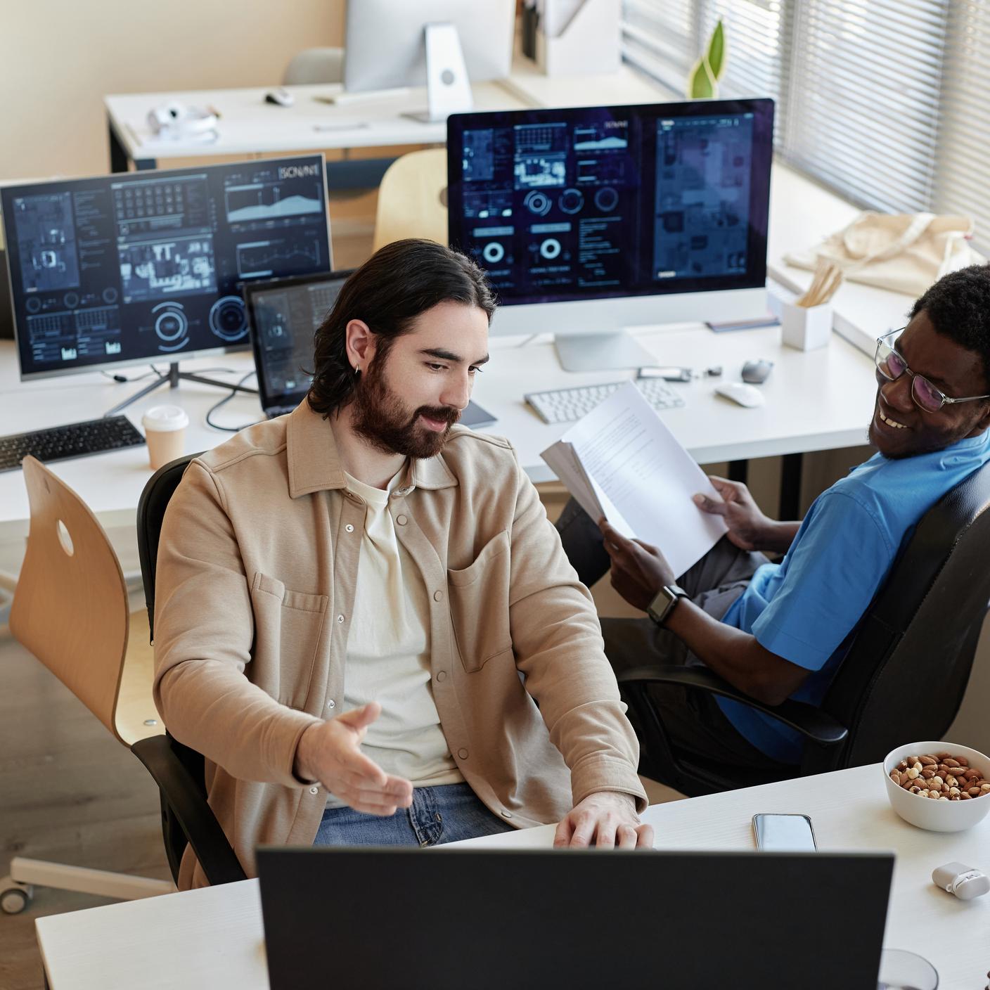 Young businessmen discussing about data on computer screen