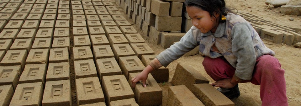 Small children doing grueling work in brick-making factories