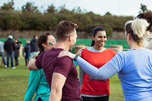 Competitors stretching before outdoor charity event