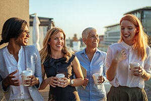 Four women standing and talking