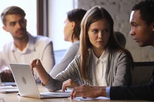 Group of people at desks talking