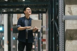 Man in warehouse with laptop