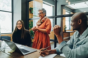 Discussion between three people at a desk