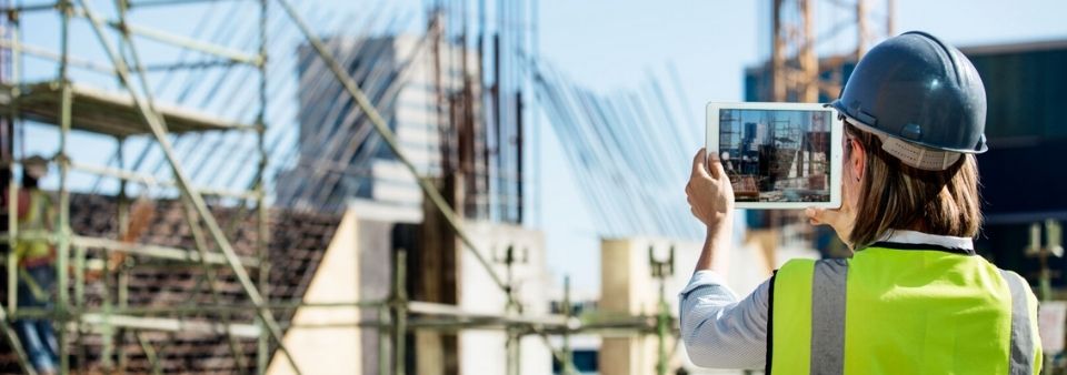 Construction worker holding tablet