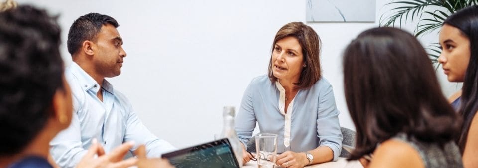 team-meeting-at-table-with-laptop