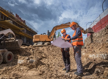 Builders inspecting the quality of a building site