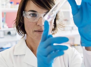 medical specialist women looking at test tube