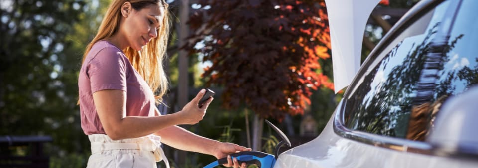 woman charging an electric vehicle