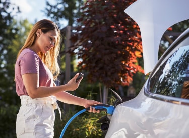 woman charging an electric vehicle