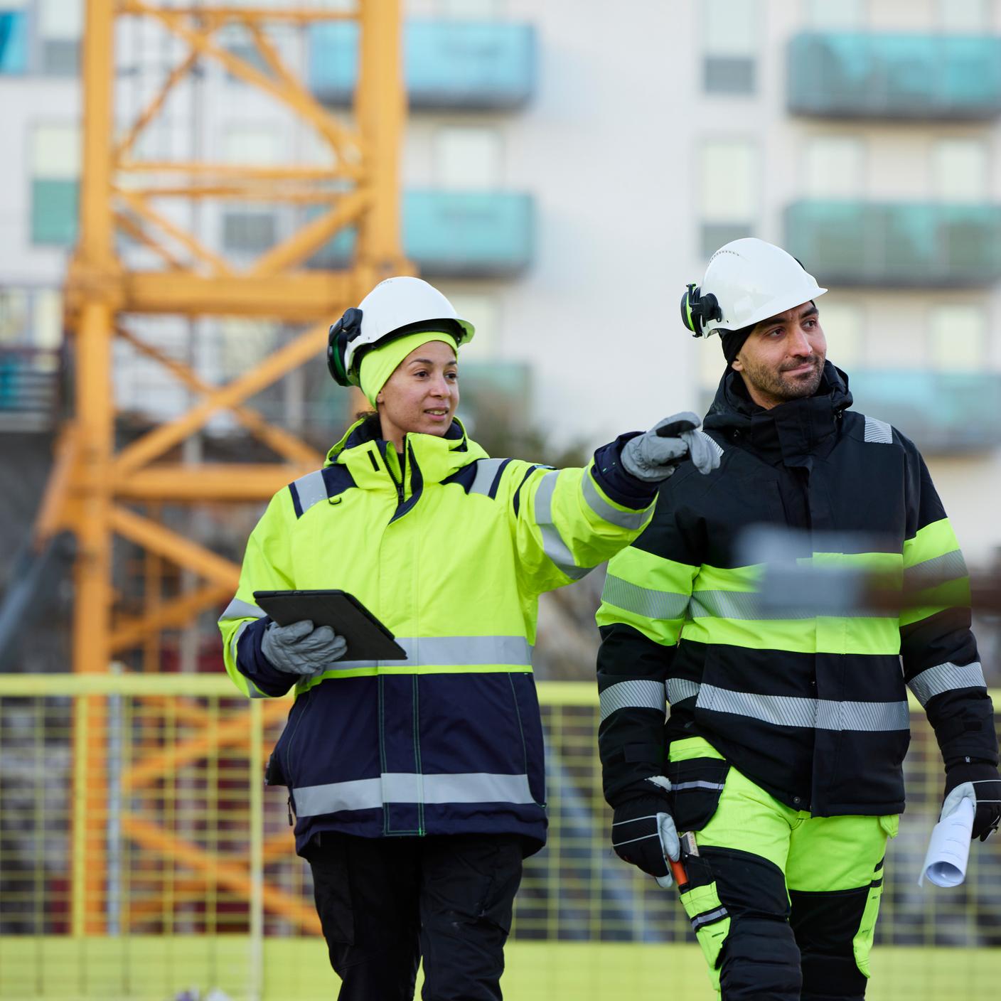 Construction engineers with a tablet at construction site