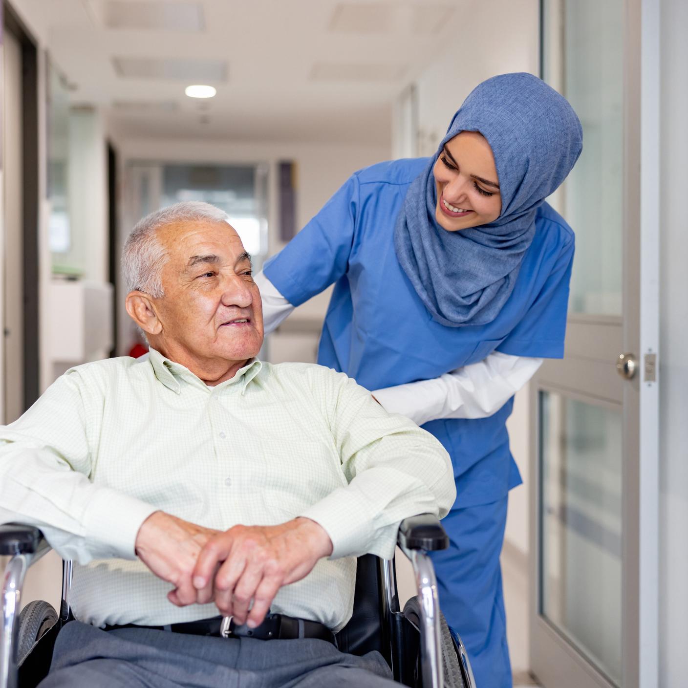 nurse pushing patient in wheelchair 