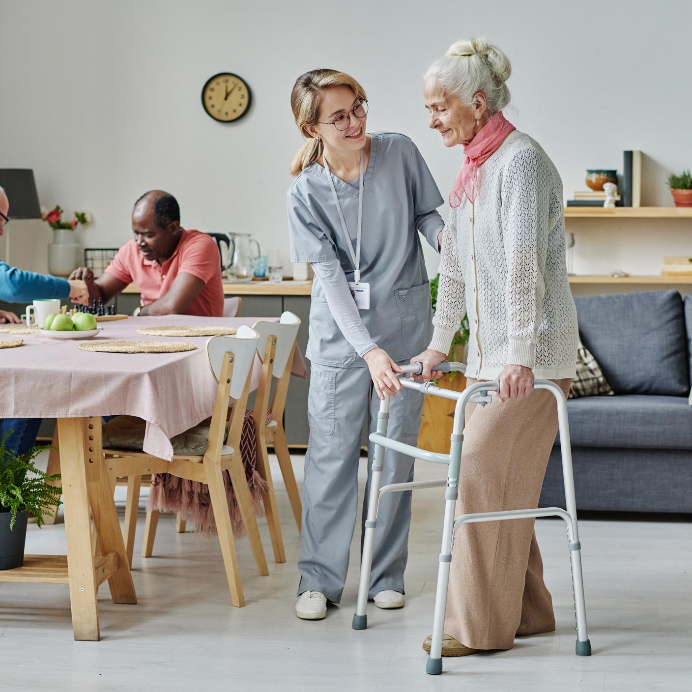 elderly woman helped by care worker.