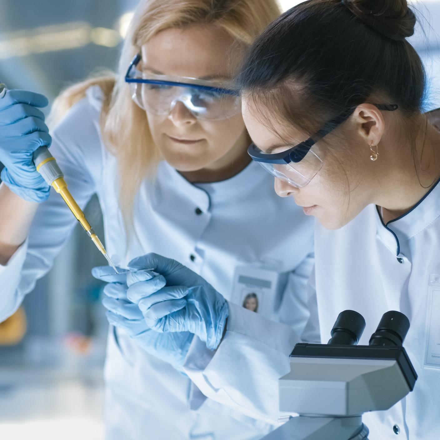 women looking at results from microscope