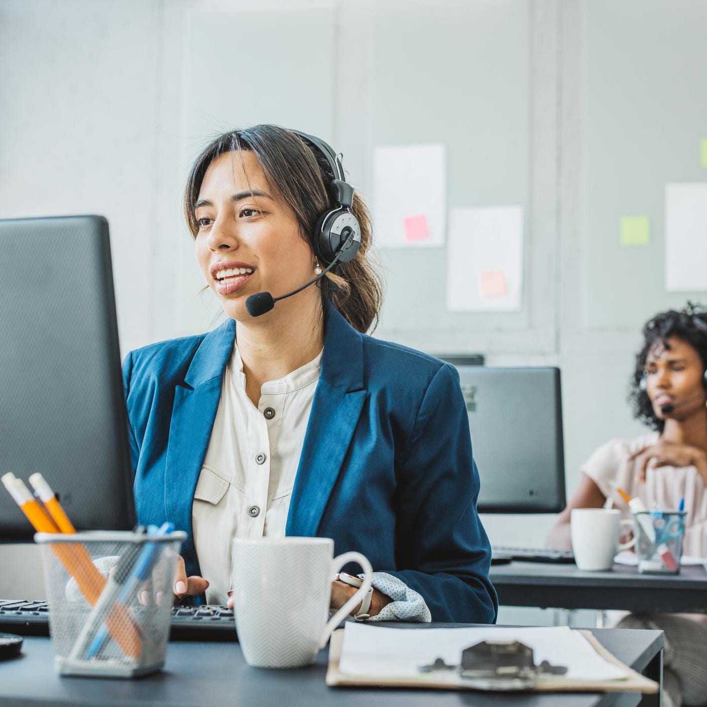 woman about desk talking through headset