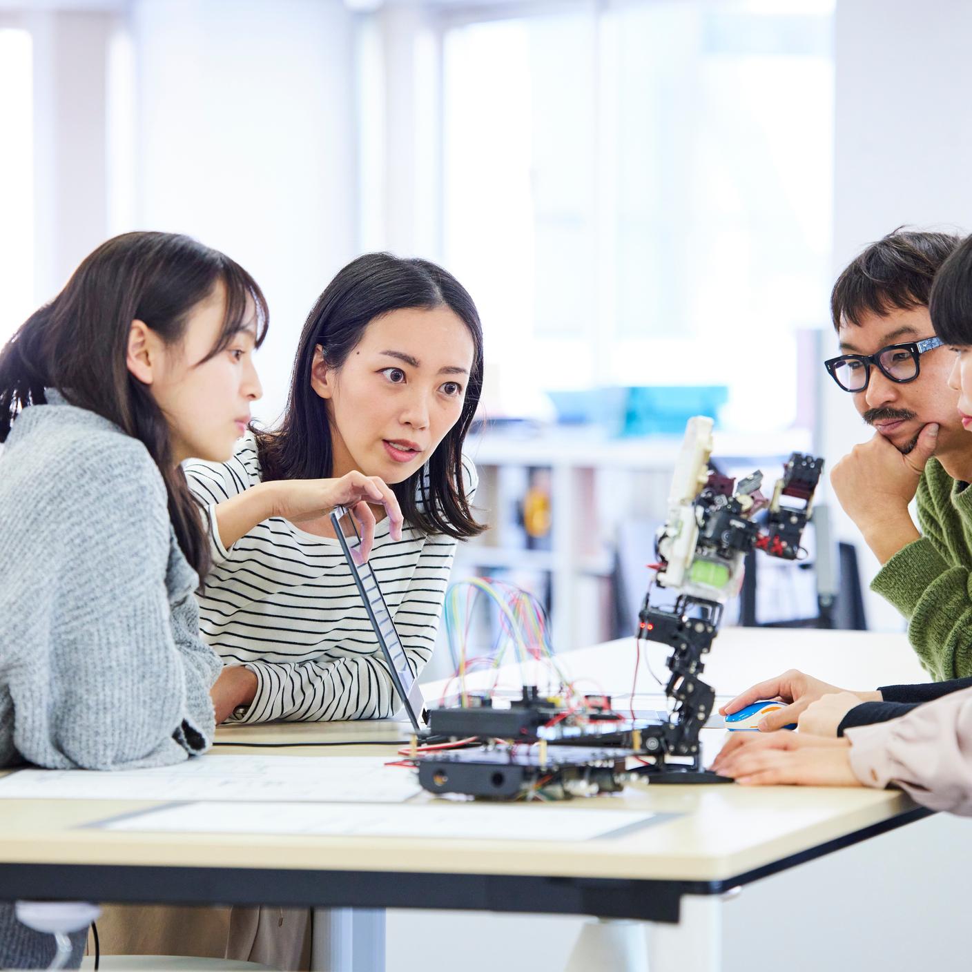 Robotics research and development team having a meeting