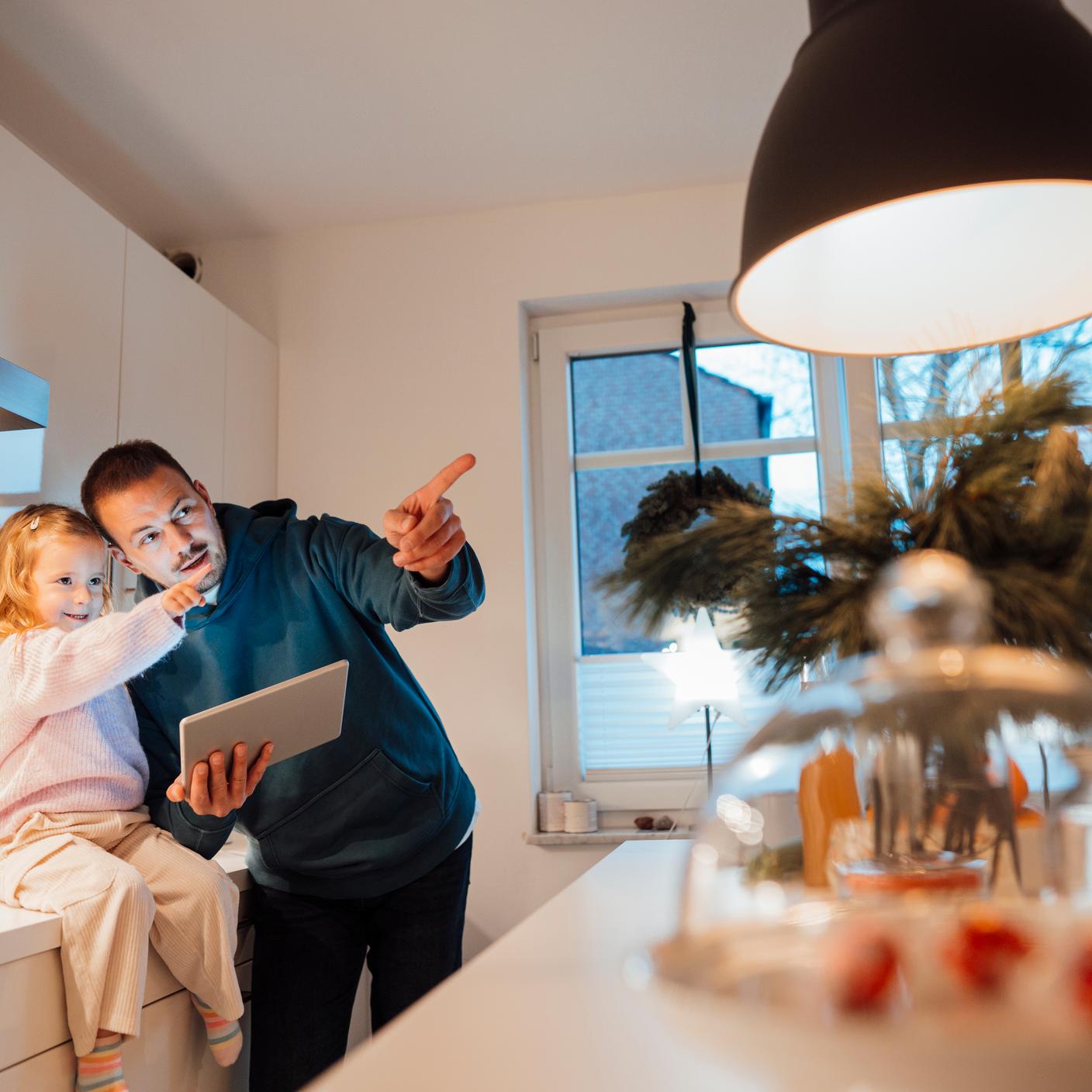 Artificial intelligence - father and daughter pointing in kitchen