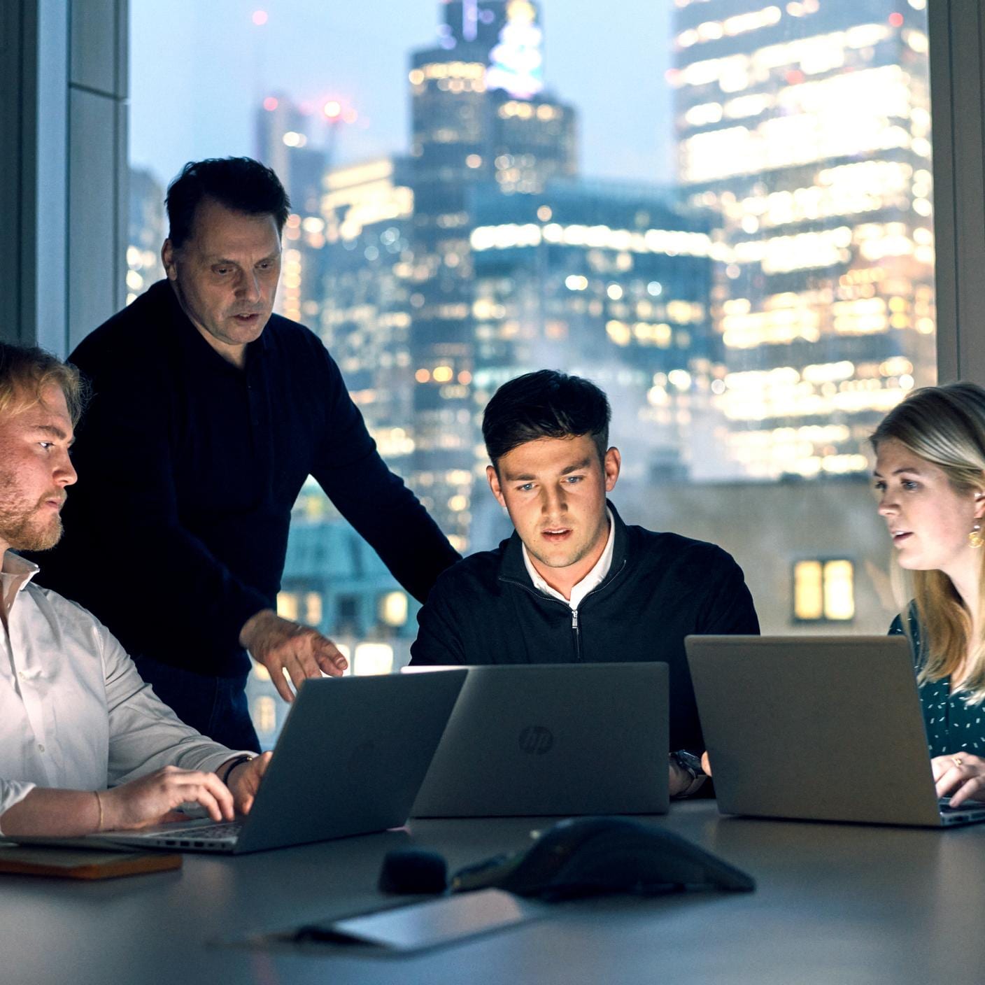 The Little Book of Cybersecurity - Professionals working on laptops