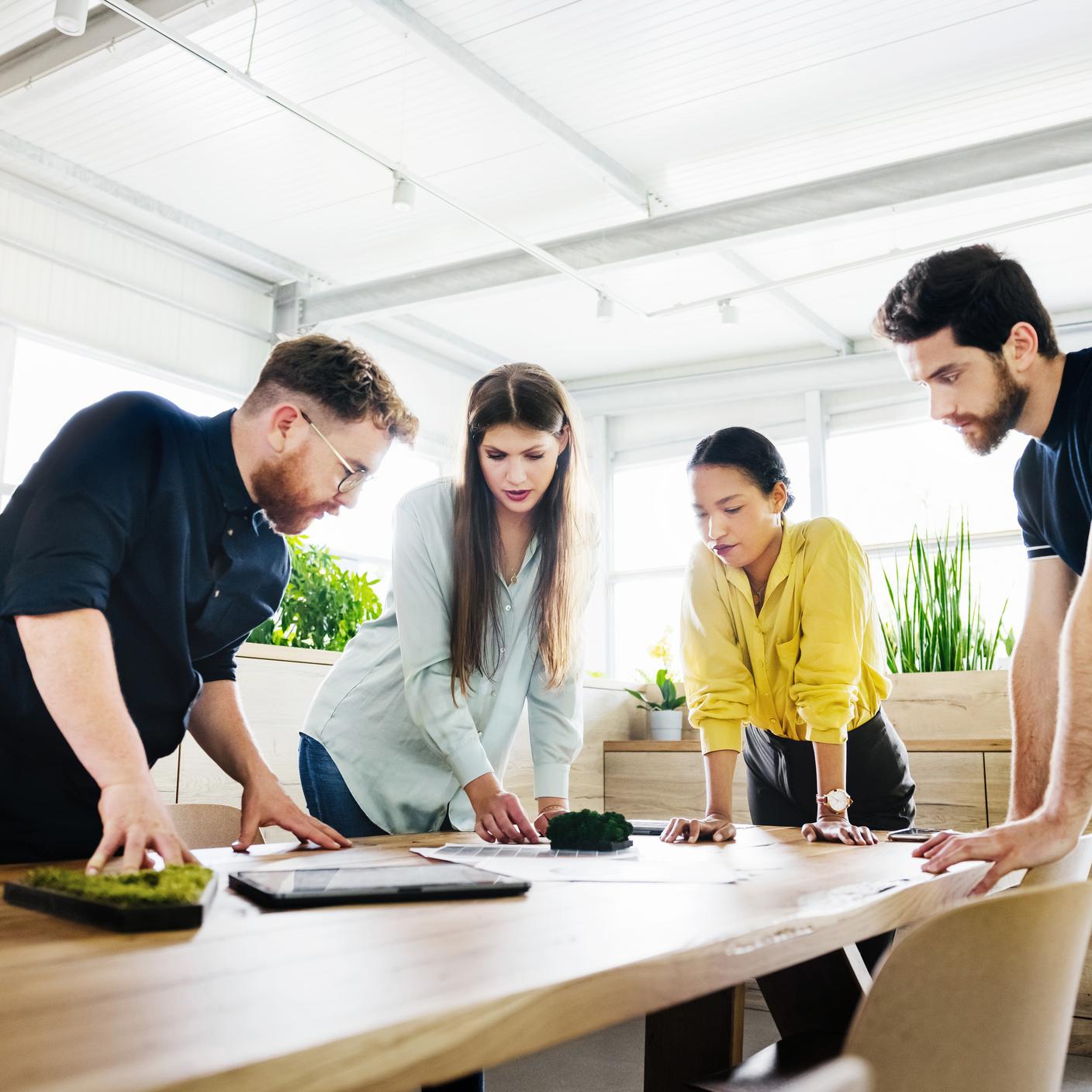 A group of young professionals around a table