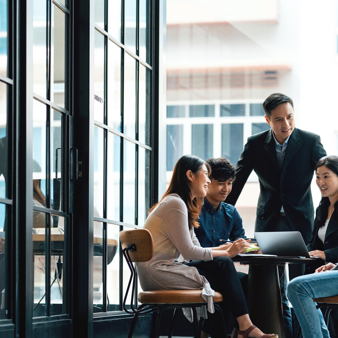 Creatives and team leader in discussion in an open working environment