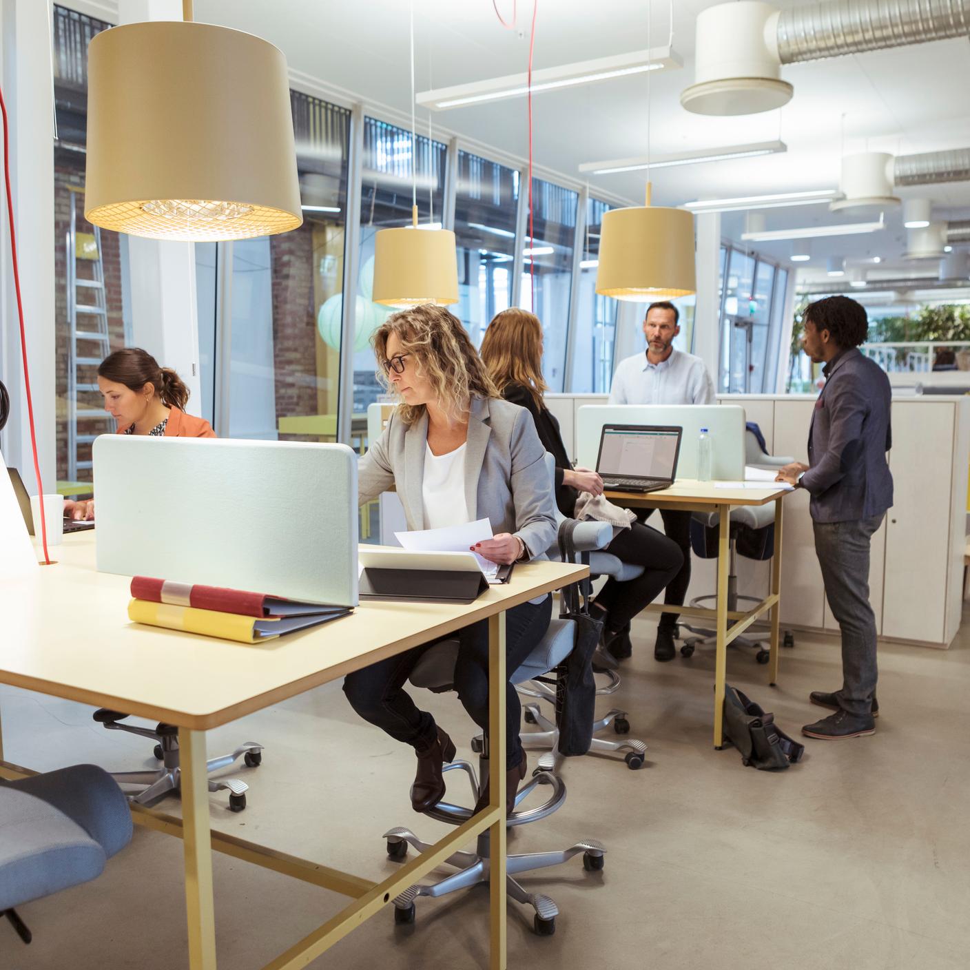 Multi-ethnic business people working at desk in office