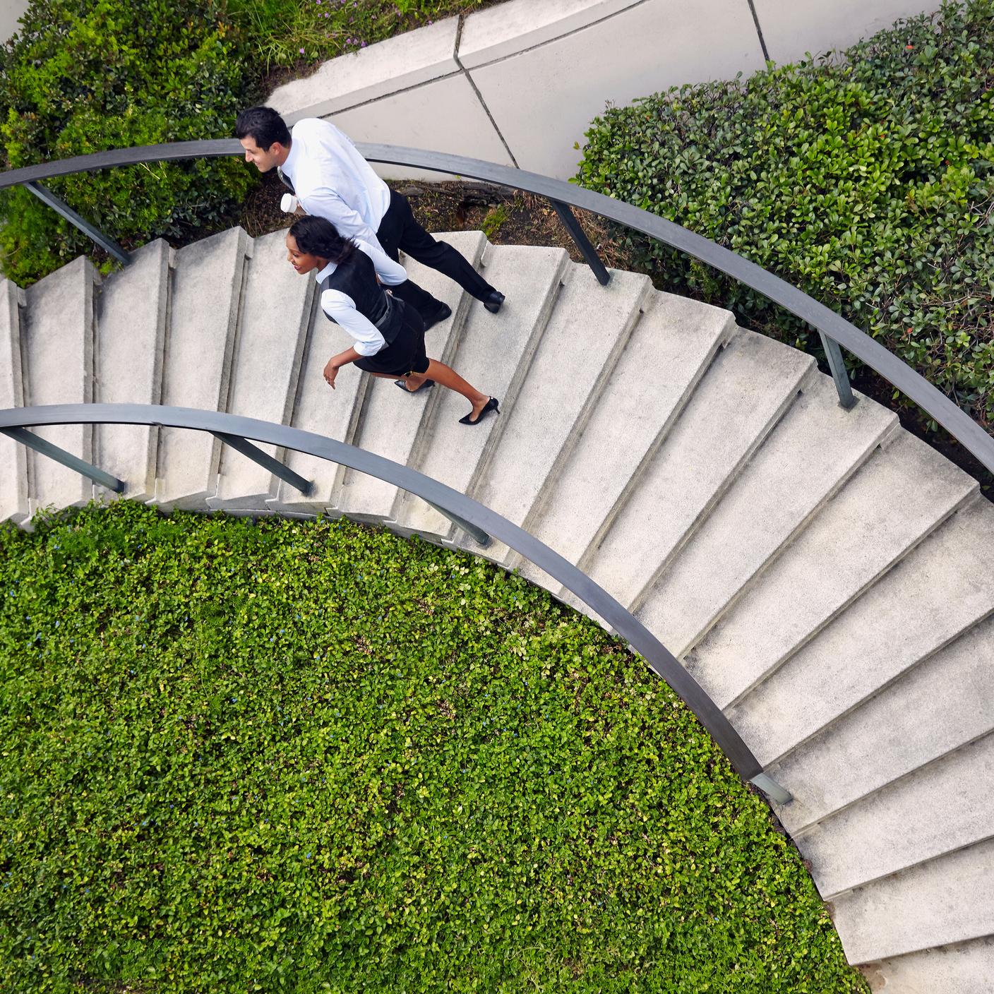 people walking around spiral steps