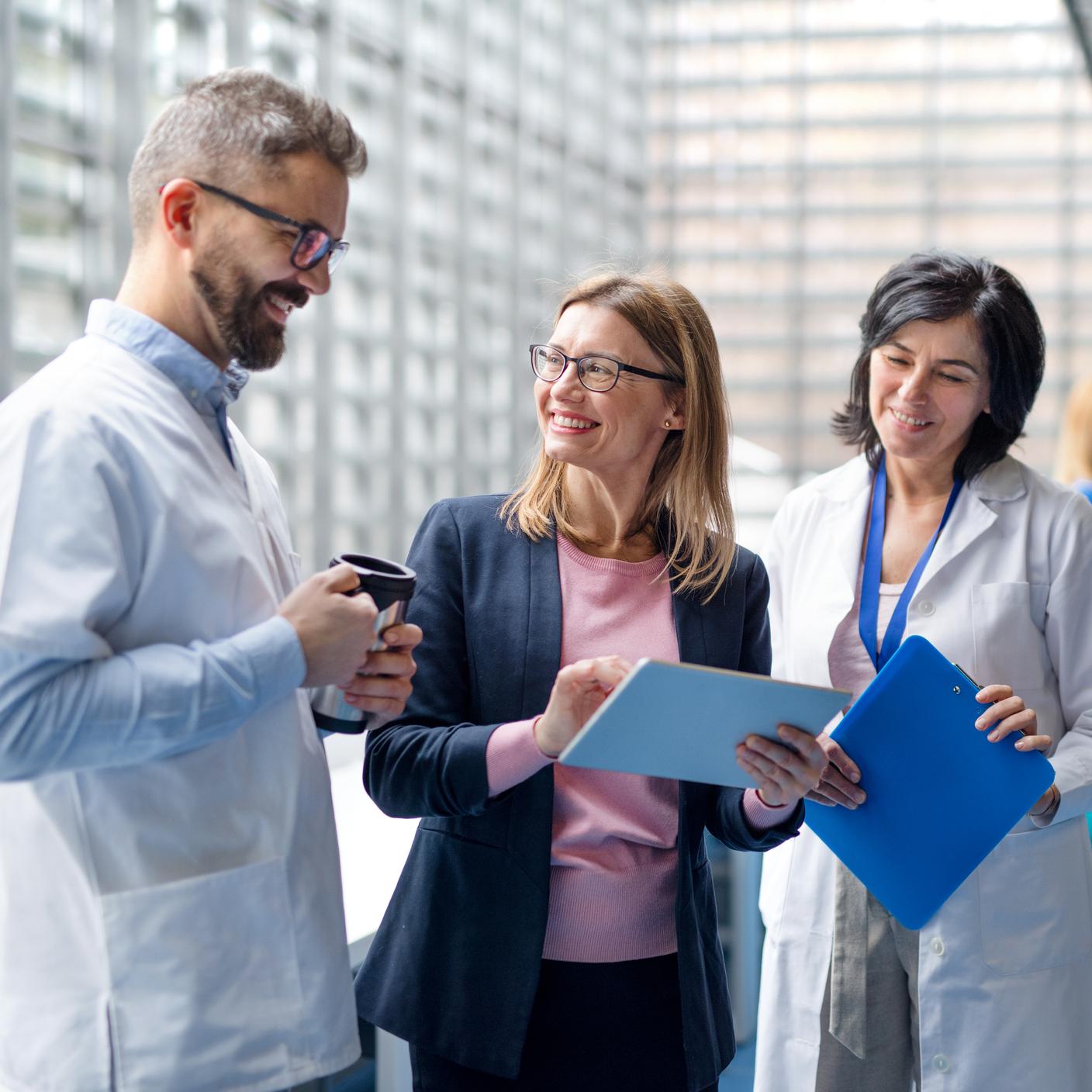 People having a discussion holding clipboards