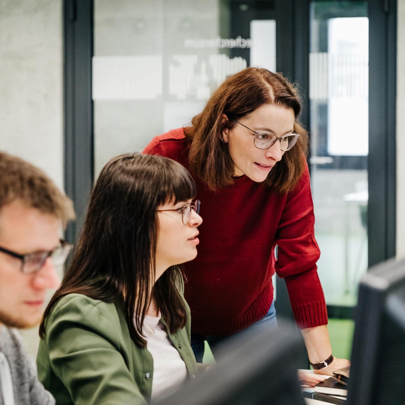 A teacher helping a student with her computer work 