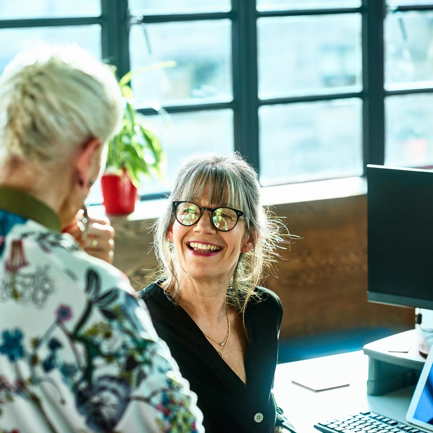 Two women discussing and laughing