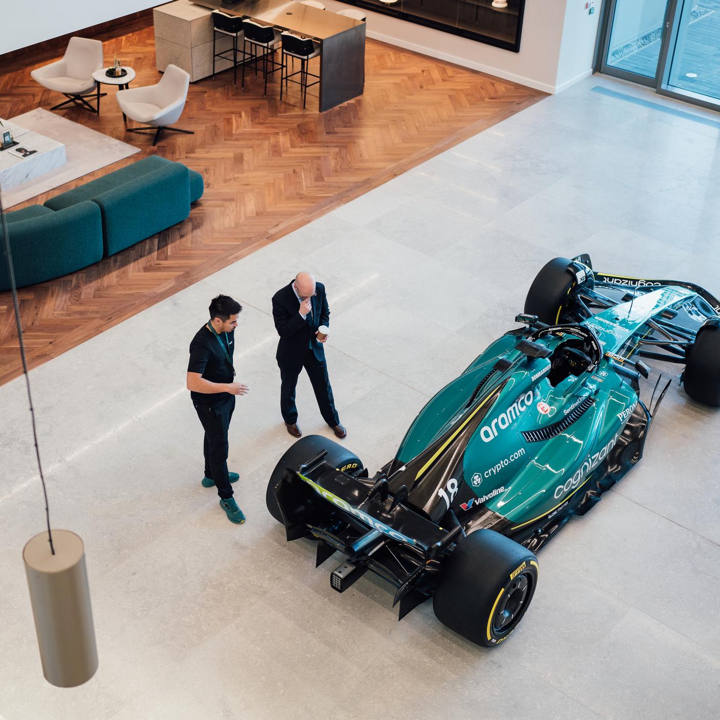 Overhead shot of Aston Martin building foyet with Forumla 1 racing car