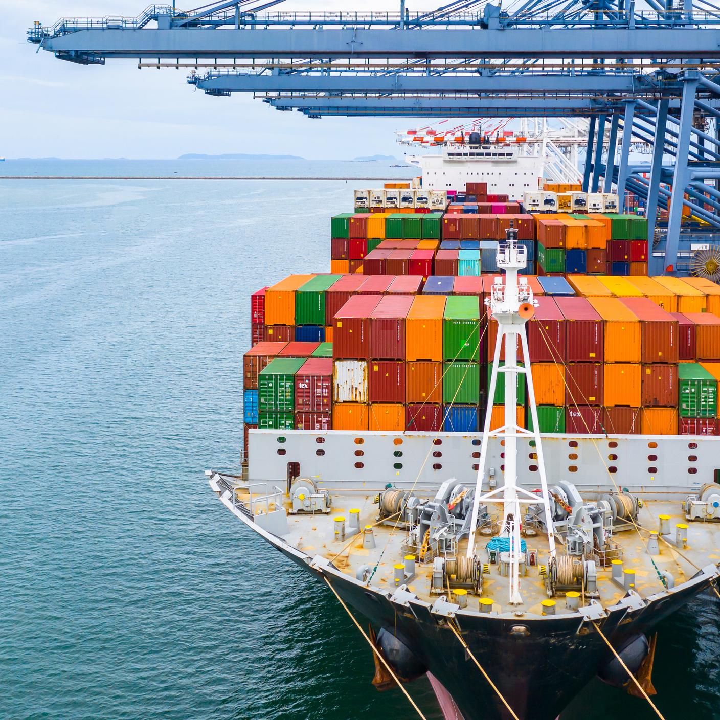 Standards Partnership programme - Cargo ship terminal, Unloading crane of cargo ship terminal, Industrial port with containers and container ship.