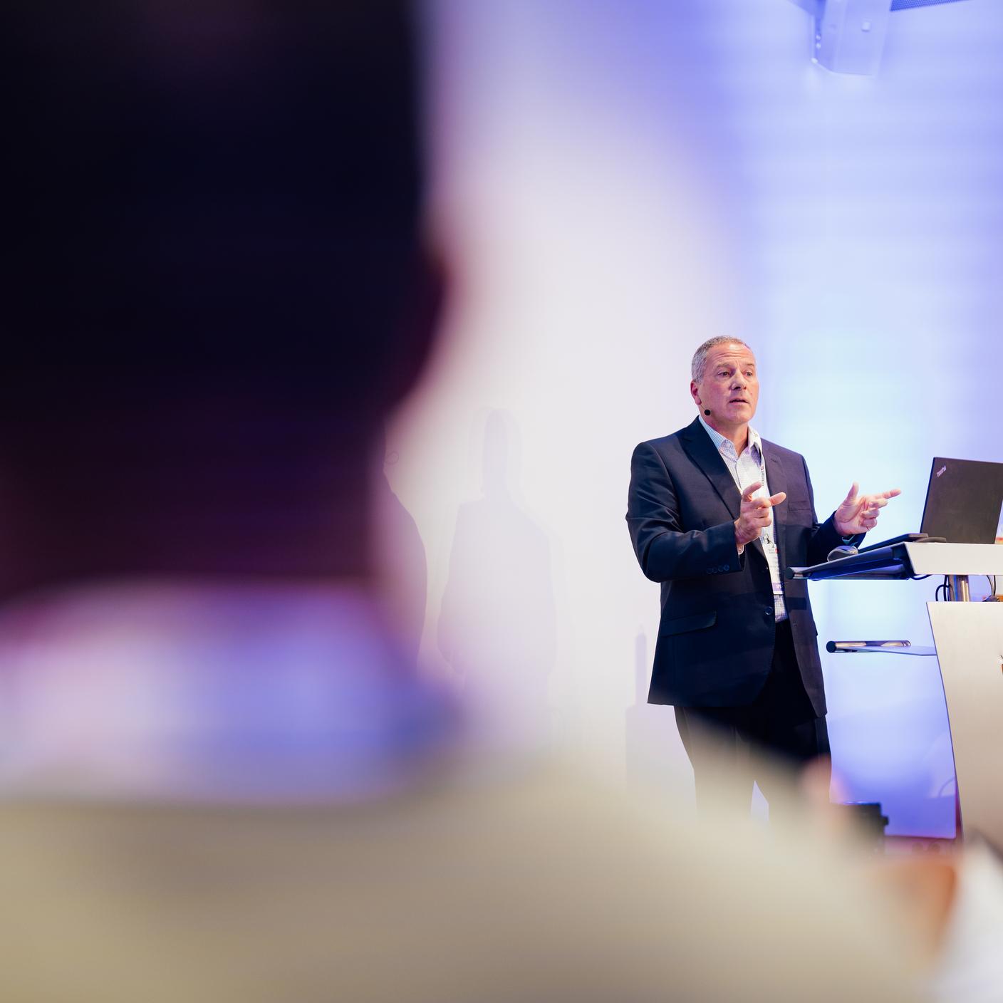 A conferencing man talking to his audience