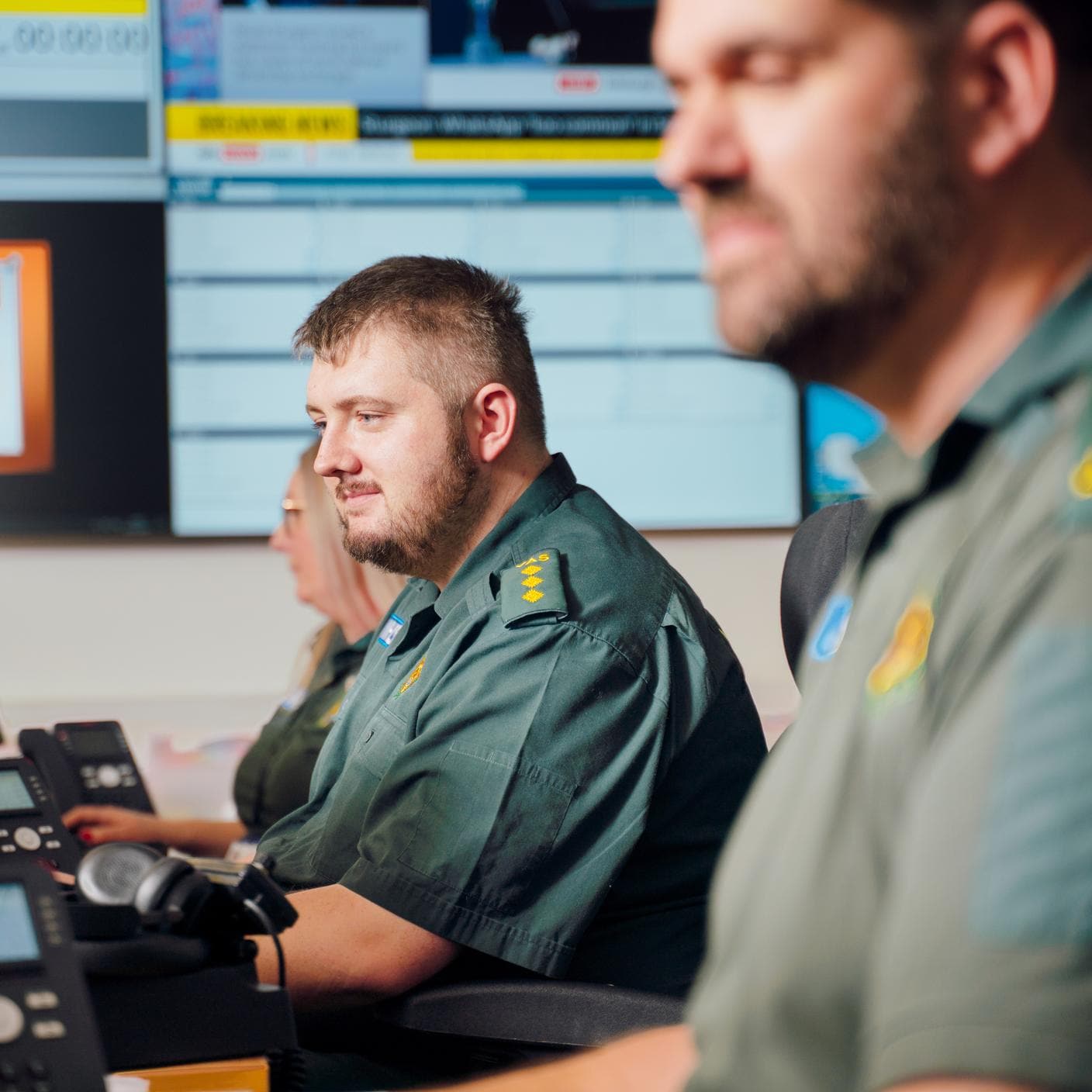 Coworkers paramedic looking at their screens in an office