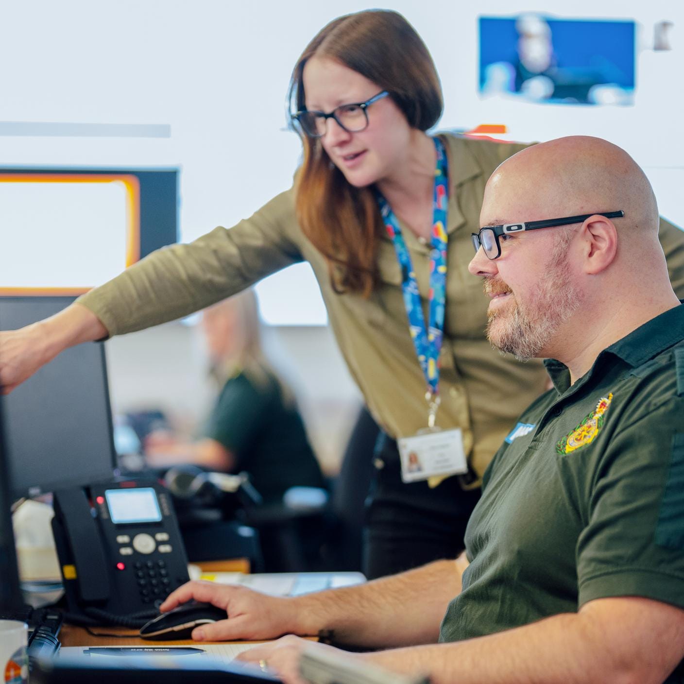 Paramedic male and woman consulting their laptop