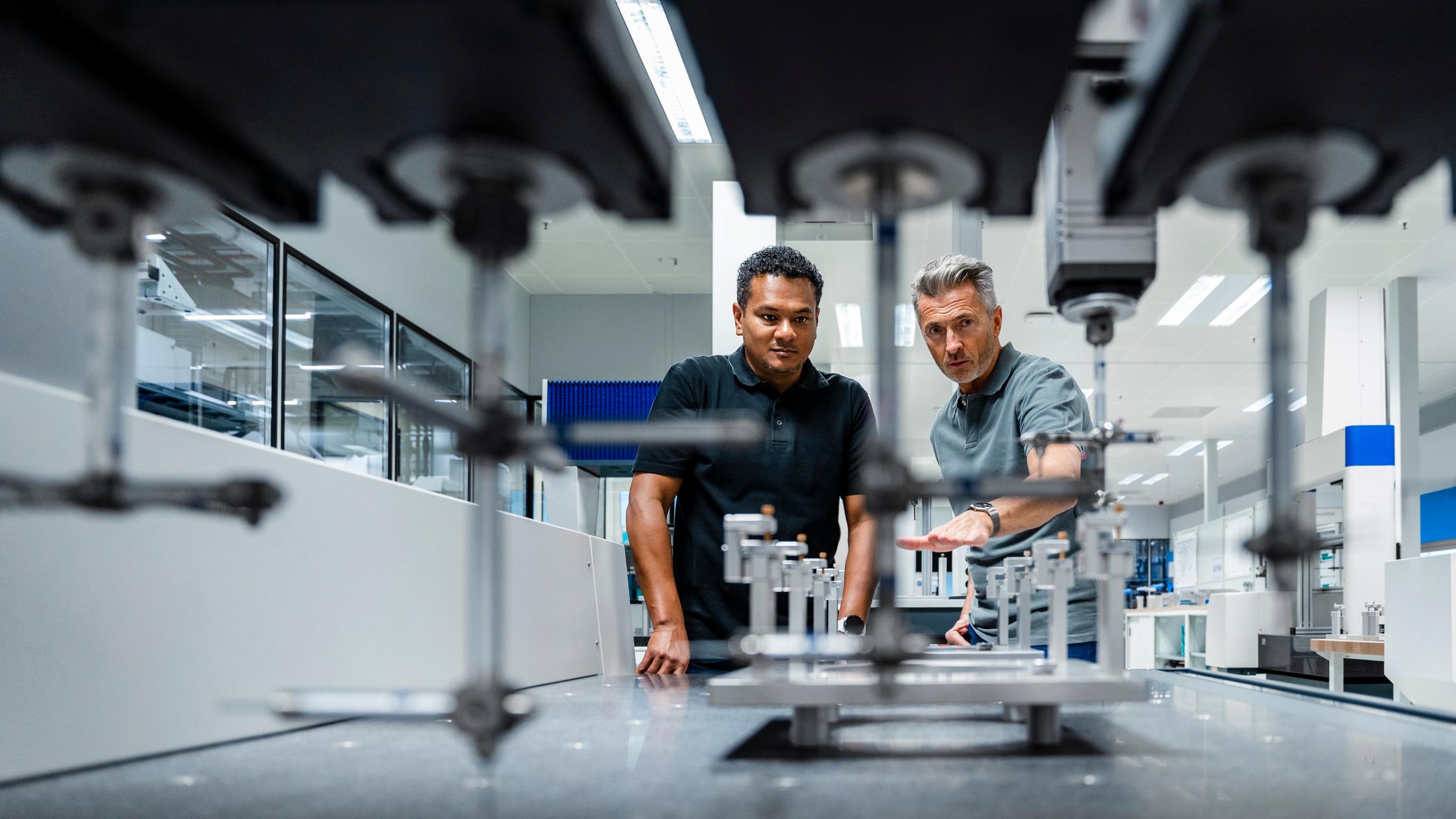 Quality : Engineers discussing over machinery at factory