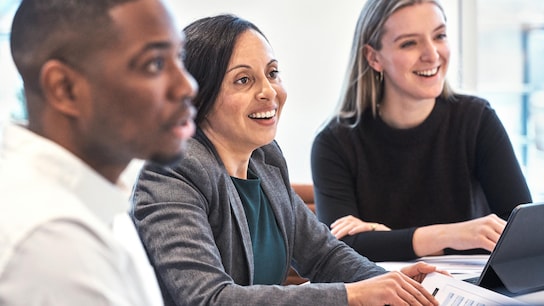 Three people chatting in a meeting