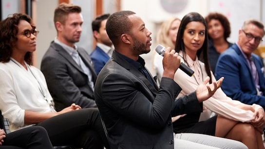 Consumer standards - business people applauding at conference