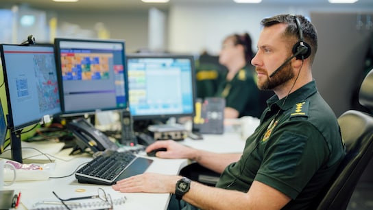 Paramedics worker in an office looking at his screen